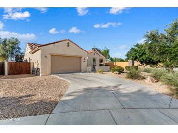 Charming single-story home with a well-maintained front yard and a two-car garage at 16158 W Coronado Rd, Goodyear, AZ 85395