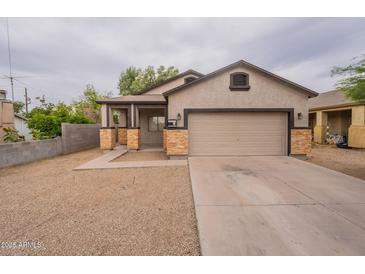 Charming single-Gathering home featuring a two-car garage and covered porch at 2210 N 27Th Pl, Phoenix, AZ 85008