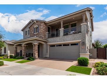 Beautiful two-story home with a stone facade, balcony, and a well-manicured front yard at 2605 S Quaintance St, Gilbert, AZ 85295