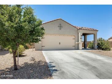 Charming single-story home featuring a well-maintained front yard and neutral-colored exterior at 4080 N 309Th Cir, Buckeye, AZ 85396
