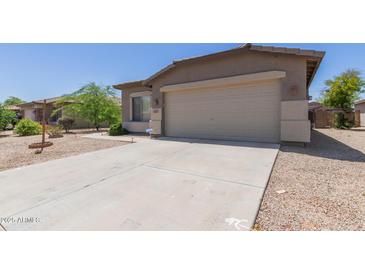 Charming single-story home with a two-car garage and a well-maintained front yard at 42347 W Bunker Dr, Maricopa, AZ 85138