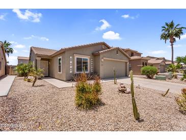 Charming single-story home featuring desert landscaping, a two-car garage, and a covered front porch at 43787 W Colby Dr, Maricopa, AZ 85138