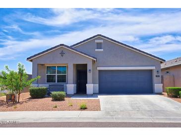 Charming single-story home featuring a well-maintained front yard and a two-car garage at 7751 W Miami St, Phoenix, AZ 85043