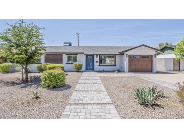 Charming single-story home boasts a blue front door, updated landscaping, and a spacious one-car garage at 1003 E Marigold Ln, Tempe, AZ 85288