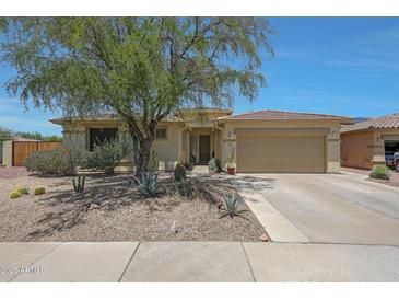 Inviting single-story home with a desert-landscaped front yard and attached two-car garage at 18550 W Mcneil St, Goodyear, AZ 85338