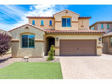 Inviting two-story home featuring a two-car garage, manicured lawn, and well-maintained front yard at 5407 S Tatum Ln, Gilbert, AZ 85298