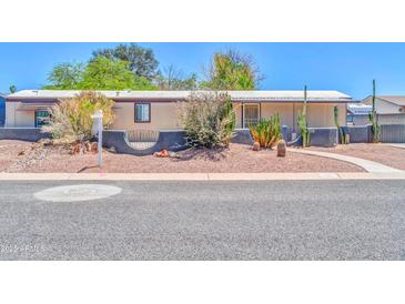 Charming single-story home featuring desert landscaping and a welcoming covered porch entry at 6921 W Wanda Lynn Ln, Peoria, AZ 85382