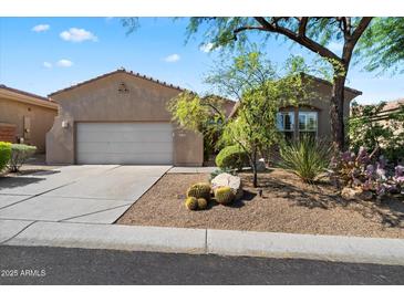 Charming single-story home featuring desert landscaping and a two-car garage at 7291 E Eagle Feather Rd, Scottsdale, AZ 85266