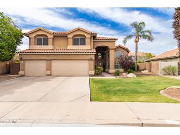 Two-story home featuring a well-manicured lawn and three-car garage at 7460 E Kiowa Ave, Mesa, AZ 85209