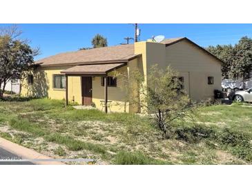 Charming single-story home with a covered porch and a well-maintained yard at 9054 E Crescent Ave, Mesa, AZ 85208