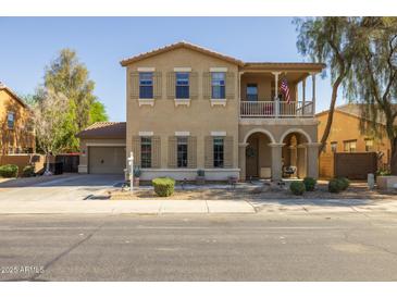 Charming two-story home featuring a welcoming porch, desert landscaping, and neutral color palette at 16206 W Cocopah St, Goodyear, AZ 85338