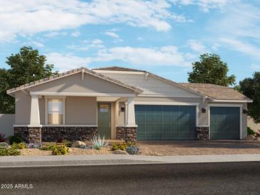 Charming single-story home featuring a three-car garage, desert landscaping, and stone accents at 17664 W Mariposa Dr, Goodyear, AZ 85395