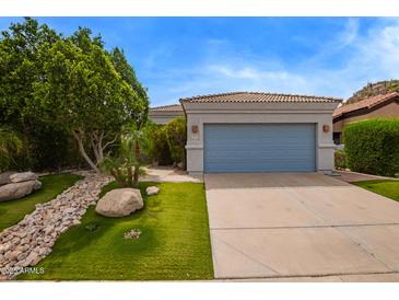 Beautiful single-story home featuring a blue garage door and desert landscaping at 19606 N 23Rd Way, Phoenix, AZ 85024