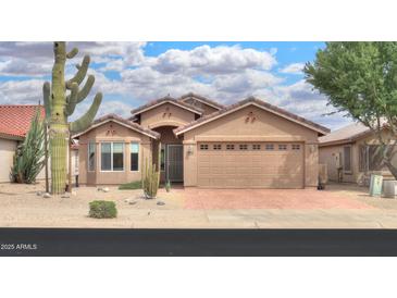 Charming single-story home with a well-manicured front yard and a two-car garage in a sunny neighborhood at 2395 E Hancock Trl, Casa Grande, AZ 85194