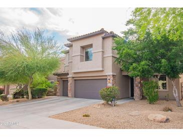 Charming two-story home featuring a tile roof, desert landscaping, and a two-car garage at 28136 N 90Th Ln, Peoria, AZ 85383