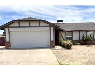 Charming single-Gathering home featuring a 2-car garage and a well-maintained front yard at 7013 W North Ln, Peoria, AZ 85345