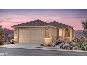 Charming single-story home boasts a desert landscape, two-car garage, and tile roof, perfect for Southwest living at 17628 W San Juan Ave, Litchfield Park, AZ 85340