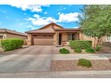 Charming single-Gathering home featuring a low maintenance front yard, two car garage, and covered porch at 21667 S 225Th Way, Queen Creek, AZ 85142