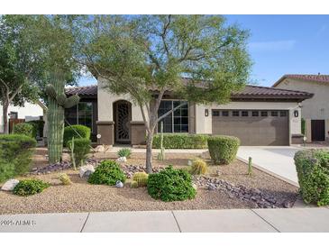 Charming home featuring desert landscaping, a two-car garage, and a decorative front door at 2991 E Fandango Dr, Gilbert, AZ 85298