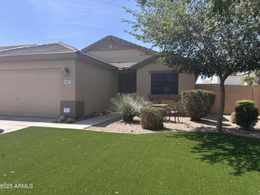 Charming single-story home with a well-maintained desert landscape and artificial grass lawn at 4657 E Del Rio Dr, San Tan Valley, AZ 85140