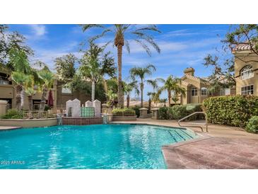 Beautiful community pool with fountains, palm trees, and well maintained landscaping at 5335 E Shea Blvd # 1094, Scottsdale, AZ 85254