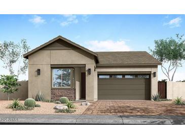 Charming single-story home with a desert landscape, stone accents, and a two-car garage at 5909 S Red Rock St, Gilbert, AZ 85298