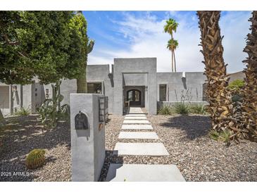 Stunning modern home featuring a desert landscape with cacti, a concrete walkway, and a neutral-toned facade at 6333 N Scottsdale Rd # 5, Scottsdale, AZ 85250