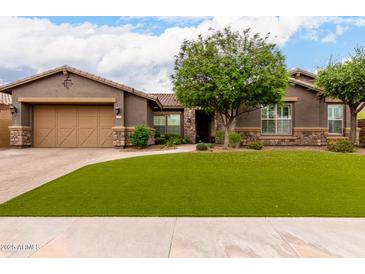 Charming single-story home with a well-manicured front yard, complemented by desert landscaping and a neutral color scheme at 12834 W Forest Pleasant Pl, Peoria, AZ 85383