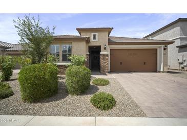 Charming single-story home featuring a well-manicured front yard and attached two-car garage at 23018 E Mewes Rd, Queen Creek, AZ 85142