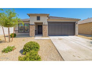 Charming single-story home with desert landscaping and a two-car garage at 24627 W Ripple Rd, Buckeye, AZ 85326