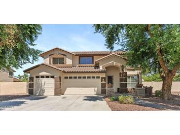 Charming two-story home featuring a three car garage, neutral paint scheme, and a well-maintained landscape at 2648 E Teakwood Pl, Chandler, AZ 85249