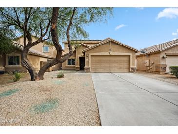 Charming single-Gathering home featuring a well-maintained yard, a desert landscape, and a two-car garage at 4587 E Silverbell Rd, San Tan Valley, AZ 85143