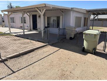 Charming single-story home with covered porch and fenced yard, offering a cozy and inviting atmosphere at 6935 W Zoe Ella Way, Peoria, AZ 85382