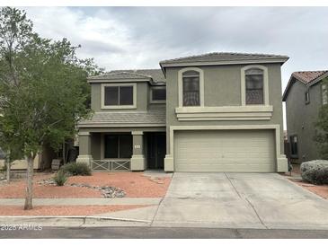Two-story home showcasing neutral paint, a well-kept front yard and a two car garage at 8514 S 49Th Dr, Laveen, AZ 85339