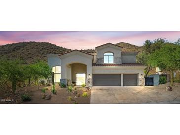 Charming two story home featuring a tile roof, stucco walls, and large two car garage at 11446 E Sweetwater Ave, Scottsdale, AZ 85259