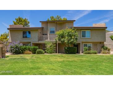 Inviting condo with green lawn, mature trees, and a private balcony at 19601 N 7Th N St # 1072, Phoenix, AZ 85024