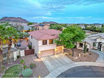 Beautiful two-story home with a three-car garage and landscaped yard in a serene community with mountain views at 27803 N 59Th Dr, Phoenix, AZ 85083