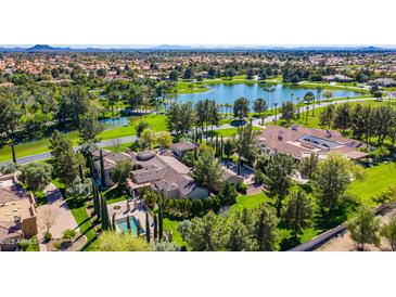 Stunning aerial view of an estate home with pool, lush landscaping, and lake views at 29 E Oakwood Hills Dr, Chandler, AZ 85248