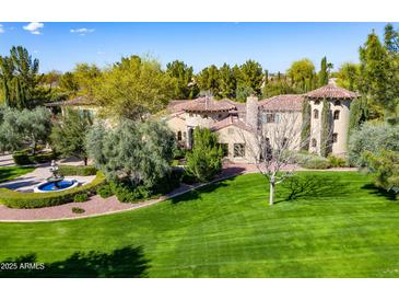 Attractive home featuring a well-manicured lawn, circular driveway, and a decorative fountain at 29 E Oakwood Hills Dr, Chandler, AZ 85248