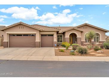 Inviting single-story home with a three-car garage and a well-maintained desert-style front yard at 2959 W Eastman Dr, Anthem, AZ 85086