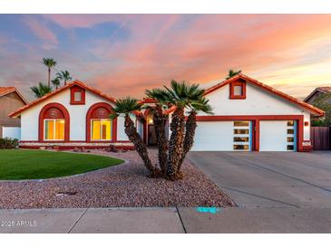 Charming single-Gathering home featuring a three-car garage, well-maintained lawn, and desert landscaping at 3037 E Mallory St, Mesa, AZ 85213