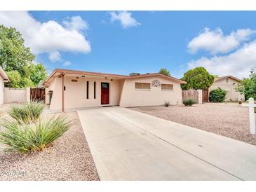 Charming single-story home with desert landscaping and a long driveway at 3124 W Port Royale Ln, Phoenix, AZ 85053