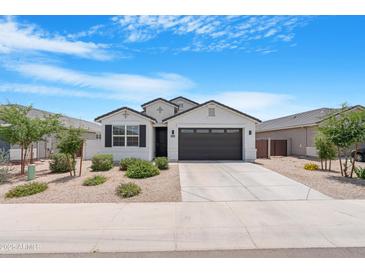 Beautiful single-story home with desert landscaping, a two-car garage, and a neutral color scheme at 35585 W San Alvarez Ave, Maricopa, AZ 85138
