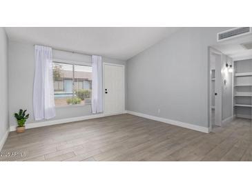 Spacious living room with tile flooring, bright natural light, and neutral paint at 3646 N 67Th Ave # 64, Phoenix, AZ 85033