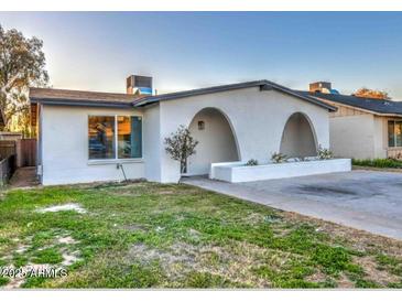 Charming home featuring an arched entryway, a modern design, and a well-maintained lawn at 5222 N 41St Ave, Phoenix, AZ 85019