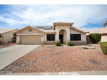 Charming single-story home featuring a well-maintained front yard, neutral color palette, and a two-car garage at 6366 W Saint John Ave, Glendale, AZ 85308