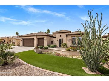 Charming home featuring beautiful landscaping, a well-maintained lawn, and a three-car garage at 654 E County Down Dr, Chandler, AZ 85249