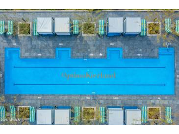 Stunning aerial view of a large community pool with cabanas and lounge chairs, perfect for relaxation and enjoyment at 7120 E Kierland Blvd # 811, Scottsdale, AZ 85254