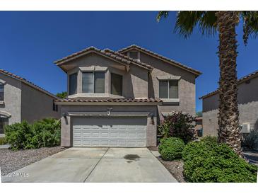 Charming two-story home featuring a well-maintained front yard and attached two-car garage at 822 E Ross Ave, Phoenix, AZ 85024
