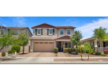 Charming two-story home with a neutral color palette, attached garage, and professionally landscaped front yard at 10224 E Talameer Ave, Mesa, AZ 85212